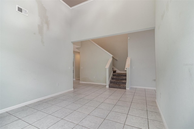 2061 Rush Bay Way, Orlando, FL 32824 - unfurnished living room with light tile patterned flooring, stairway, a high ceiling, and crown molding