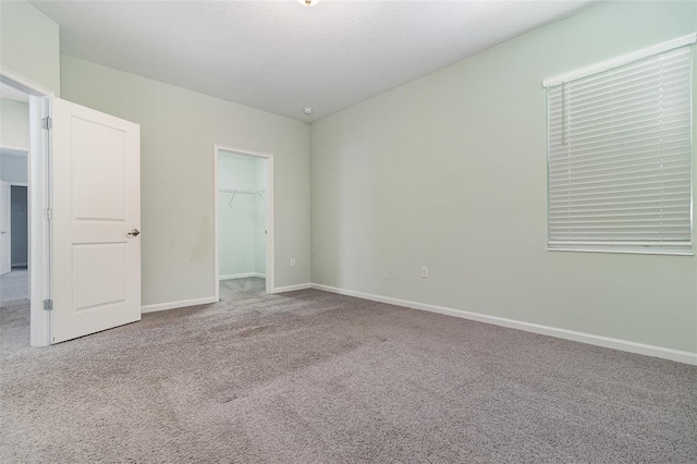 2061 Rush Bay Way, Orlando, FL 32824 - unfurnished bedroom featuring carpet, a walk in closet, and a closet