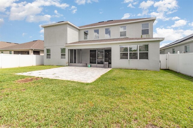 2061 Rush Bay Way, Orlando, FL 32824 - rear view of house featuring stucco siding, a patio area, a sunroom, and a fenced backyard