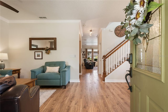 402 S Lake Victoria Cir, Deland, FL 32724 - foyer entrance with crown molding, light wood finished floors, stairs, and baseboards