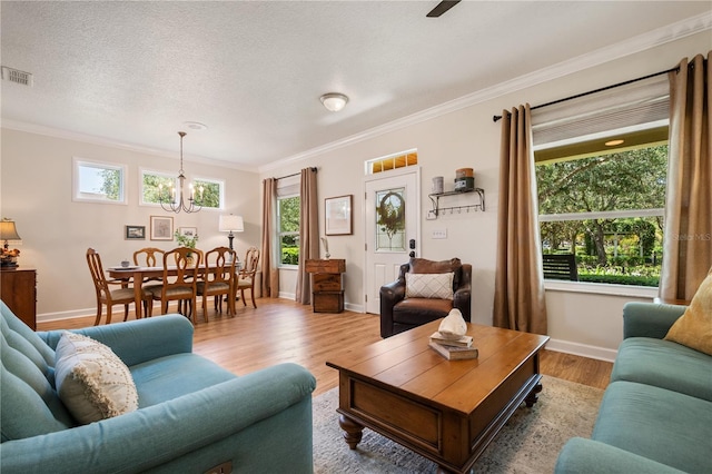 402 S Lake Victoria Cir, Deland, FL 32724 - living area featuring ornamental molding, a chandelier, baseboards, and wood finished floors