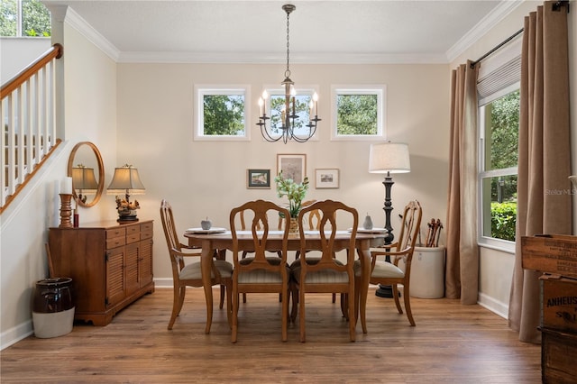 402 S Lake Victoria Cir, Deland, FL 32724 - dining space with a chandelier, crown molding, wood finished floors, plenty of natural light, and baseboards