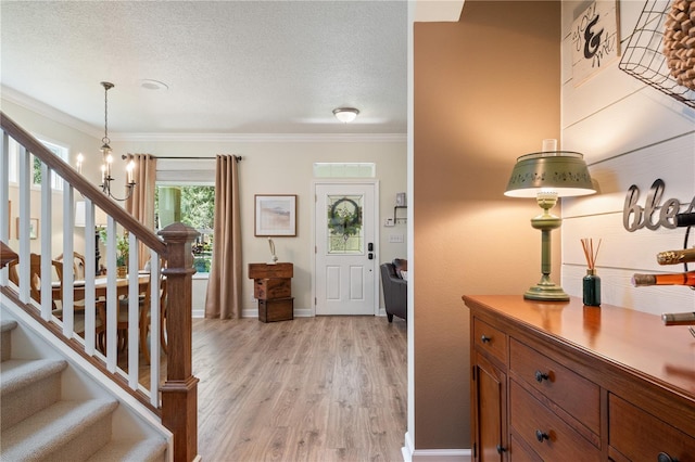 402 S Lake Victoria Cir, Deland, FL 32724 - entryway featuring ornamental molding, light wood-style floors, stairway, baseboards, and a textured ceiling