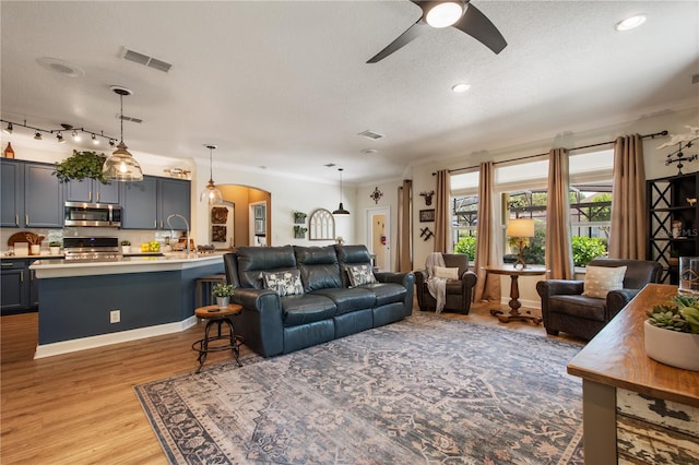 402 S Lake Victoria Cir, Deland, FL 32724 - living area with a textured ceiling, ceiling fan, light wood-type flooring, recessed lighting, and arched walkways