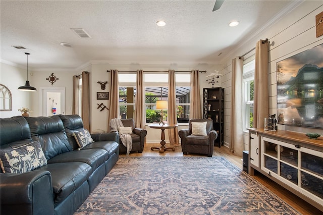 402 S Lake Victoria Cir, Deland, FL 32724 - living area with wood finished floors, a textured ceiling, ornamental molding, healthy amount of natural light, and recessed lighting