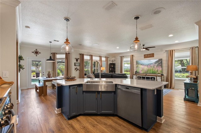 402 S Lake Victoria Cir, Deland, FL 32724 - kitchen featuring appliances with stainless steel finishes, a sink, a textured ceiling, light countertops, and open floor plan