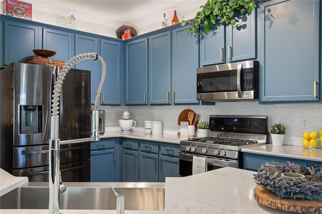 402 S Lake Victoria Cir, Deland, FL 32724 - kitchen with stainless steel appliances, blue cabinetry, tasteful backsplash, and crown molding