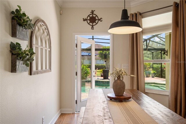 402 S Lake Victoria Cir, Deland, FL 32724 - doorway to outside featuring crown molding, baseboards, and light wood-style flooring