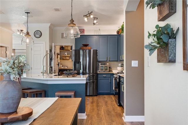 402 S Lake Victoria Cir, Deland, FL 32724 - kitchen featuring appliances with stainless steel finishes, decorative backsplash, a kitchen breakfast bar, light countertops, and pendant lighting
