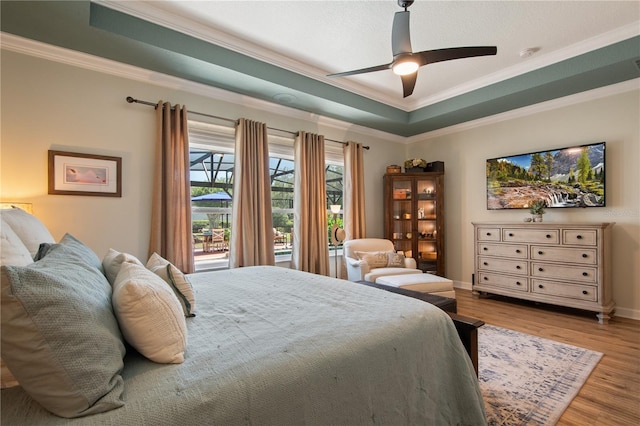 402 S Lake Victoria Cir, Deland, FL 32724 - bedroom with crown molding, wood finished floors, baseboards, a ceiling fan, and a tray ceiling