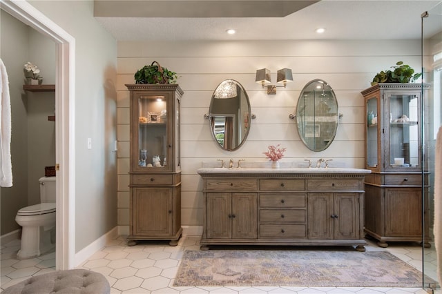 402 S Lake Victoria Cir, Deland, FL 32724 - bathroom with double vanity, toilet, tile patterned floors, recessed lighting, and baseboards