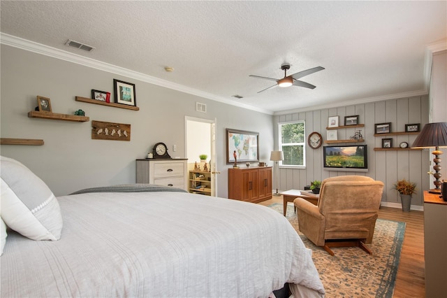 402 S Lake Victoria Cir, Deland, FL 32724 - bedroom featuring wood finished floors, ornamental molding, a textured ceiling, and a ceiling fan