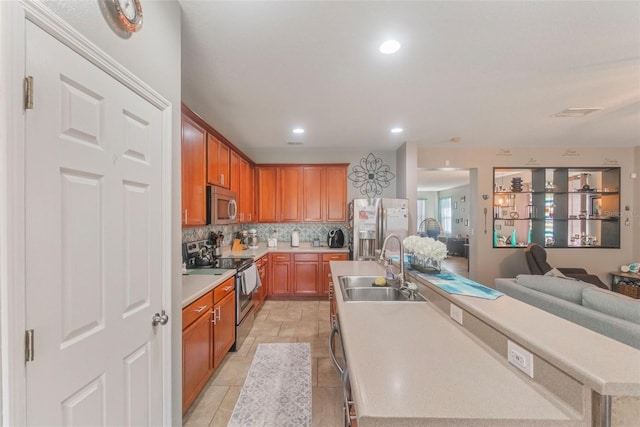 2619 Breezy Meadow Rd, Apopka, FL 32712 - kitchen featuring stainless steel appliances, a sink, a kitchen island with sink, decorative backsplash, and open floor plan