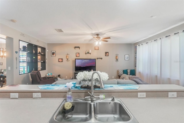 2619 Breezy Meadow Rd, Apopka, FL 32712 - kitchen featuring a sink, open floor plan, ceiling fan, and light countertops