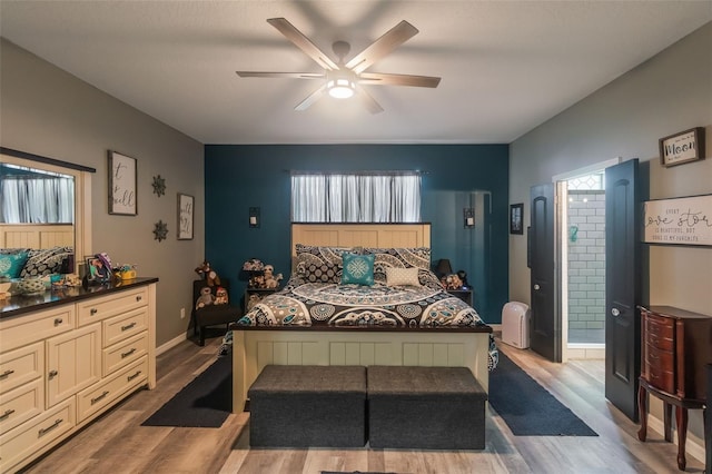 2619 Breezy Meadow Rd, Apopka, FL 32712 - bedroom with wood finished floors, multiple windows, ensuite bath, and baseboards