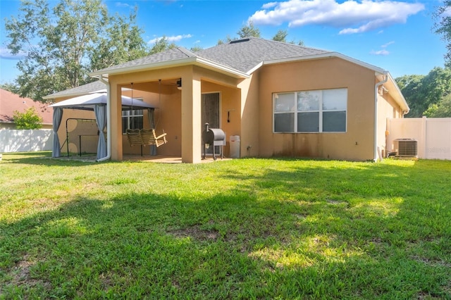 2619 Breezy Meadow Rd, Apopka, FL 32712 - rear view of house with stucco siding, a gazebo, central air condition unit, a patio area, and a shingled roof