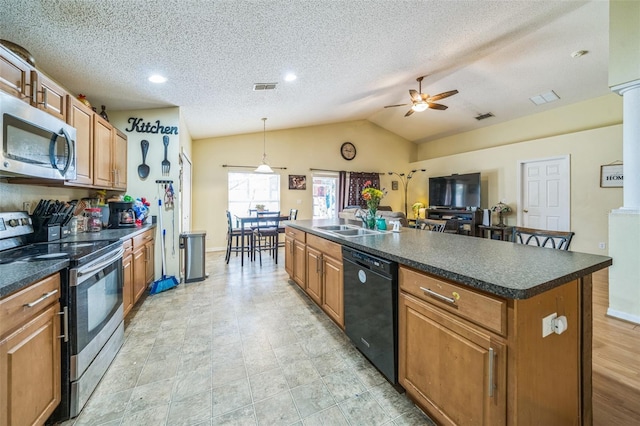 2354 Barons Ct, Tavares, FL 32778 - kitchen featuring stainless steel appliances, ceiling fan, a sink, dark countertops, and lofted ceiling