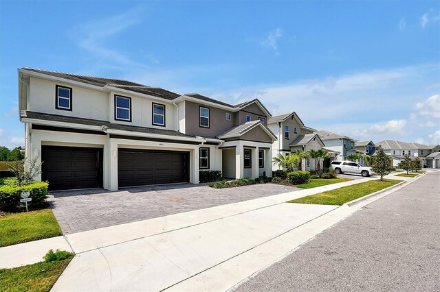 3860 Sonoma Blvd, Kissimmee, FL 34741 - multi unit property featuring a residential view, a garage, decorative driveway, and stucco siding