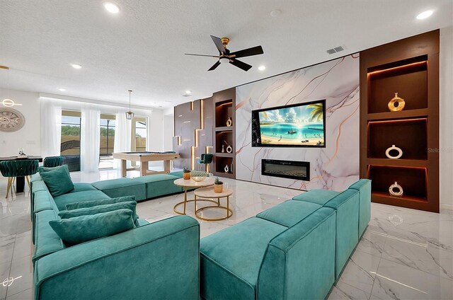 3860 Sonoma Blvd, Kissimmee, FL 34741 - living room featuring marble tiled floors, built in features, a ceiling fan, recessed lighting, and a textured ceiling