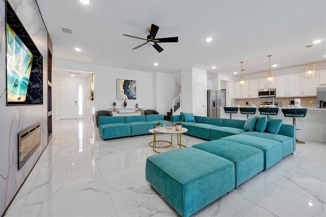 3860 Sonoma Blvd, Kissimmee, FL 34741 - living room featuring light marble finish flooring, stairs, recessed lighting, ceiling fan, and heating unit