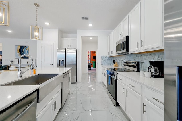 3860 Sonoma Blvd, Kissimmee, FL 34741 - kitchen featuring stainless steel appliances, light marble finish flooring, a sink, white cabinetry, and recessed lighting
