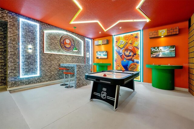 3860 Sonoma Blvd, Kissimmee, FL 34741 - playroom with finished concrete flooring, a textured ceiling, and a dry bar