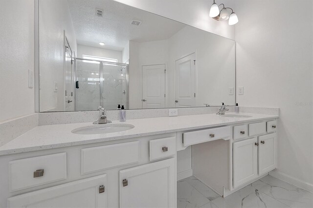 3860 Sonoma Blvd, Kissimmee, FL 34741 - full bathroom with double vanity, a marble finish shower, baseboards, marble finish flooring, and a textured ceiling