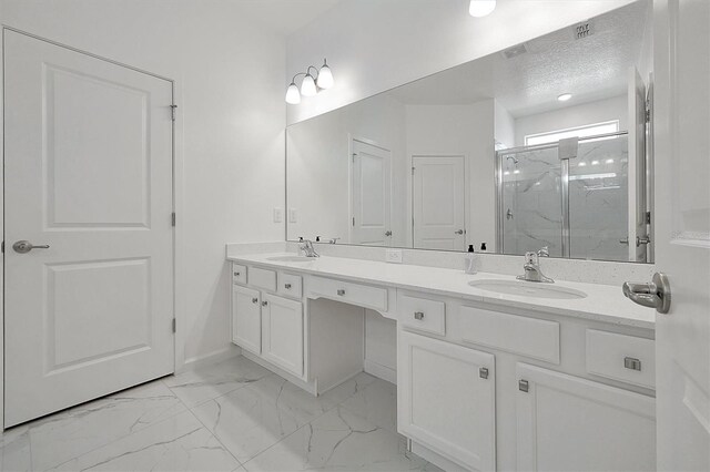 3860 Sonoma Blvd, Kissimmee, FL 34741 - bathroom with a marble finish shower, double vanity, marble finish flooring, a textured ceiling, and baseboards