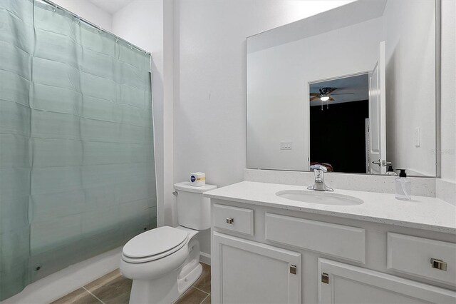 3860 Sonoma Blvd, Kissimmee, FL 34741 - full bathroom with vanity, ceiling fan, a shower with shower curtain, toilet, and tile patterned flooring