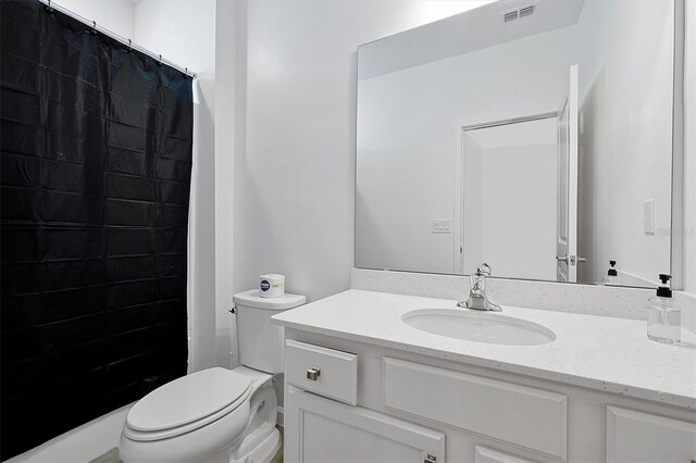 3860 Sonoma Blvd, Kissimmee, FL 34741 - bathroom featuring vanity, toilet, and tiled shower