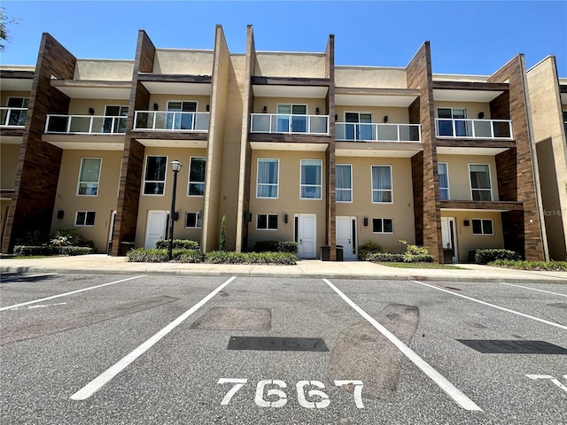 7667 Recife Dr, Kissimmee, FL 34747 - view of apartment building / complex with uncovered parking