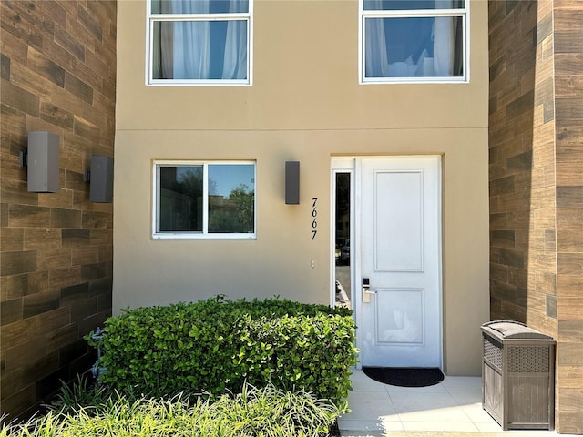 7667 Recife Dr, Kissimmee, FL 34747 - property entrance with stucco siding