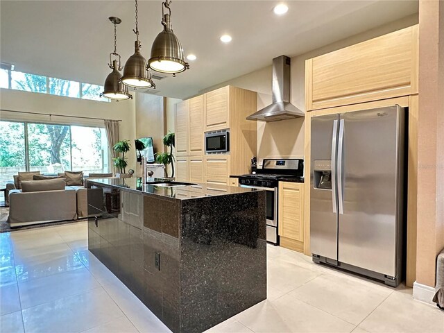 7667 Recife Dr, Kissimmee, FL 34747 - kitchen featuring stainless steel appliances, wall chimney range hood, recessed lighting, light tile patterned floors, and light brown cabinets
