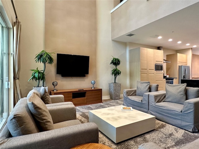 7667 Recife Dr, Kissimmee, FL 34747 - living area featuring carpet, baseboards, recessed lighting, and a high ceiling