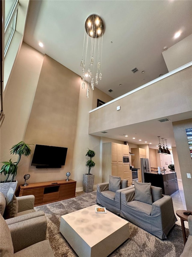 7667 Recife Dr, Kissimmee, FL 34747 - living room with light colored carpet, a towering ceiling, baseboards, and recessed lighting