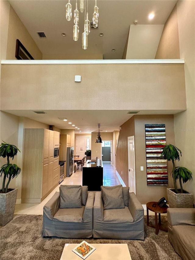 7667 Recife Dr, Kissimmee, FL 34747 - living room featuring baseboards, recessed lighting, a chandelier, and a high ceiling
