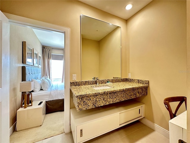 7667 Recife Dr, Kissimmee, FL 34747 - bathroom with vanity, baseboards, tile patterned flooring, and recessed lighting