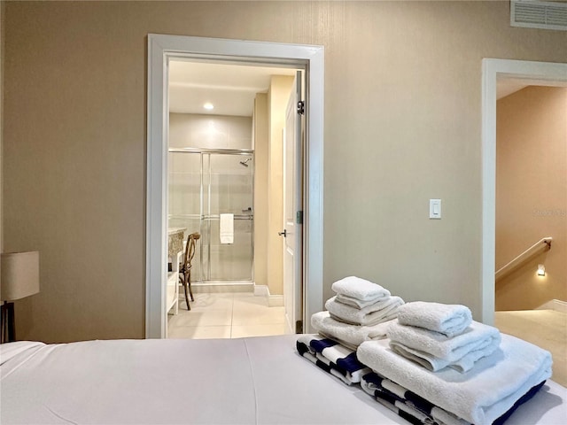 7667 Recife Dr, Kissimmee, FL 34747 - bedroom with light tile patterned floors, connected bathroom, and baseboards