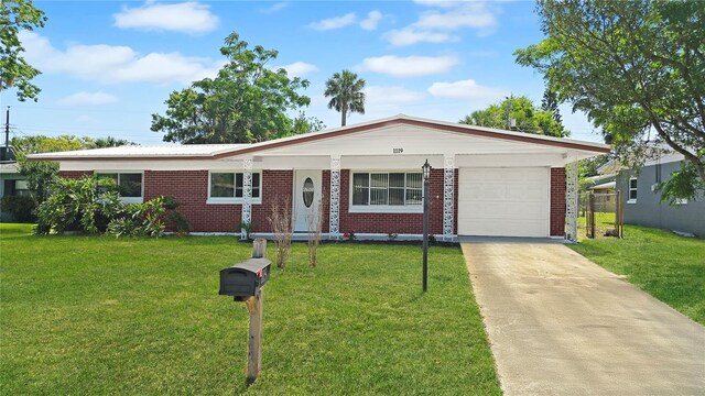 1119 Edith Dr, Daytona Beach, FL 32117 - single story home with brick siding, an attached garage, a front lawn, and driveway