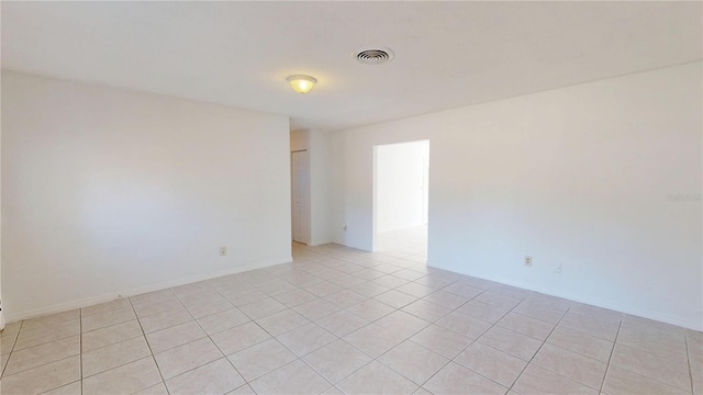 1119 Edith Dr, Daytona Beach, FL 32117 - empty room featuring light tile patterned flooring and baseboards