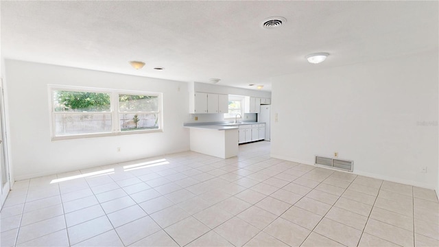1119 Edith Dr, Daytona Beach, FL 32117 - unfurnished living room with a sink and light tile patterned flooring