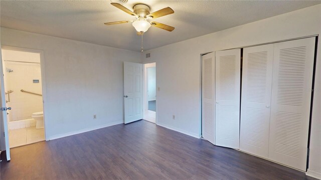 1119 Edith Dr, Daytona Beach, FL 32117 - unfurnished bedroom with dark wood finished floors, a closet, ensuite bathroom, and a ceiling fan