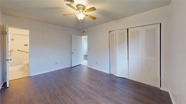 1119 Edith Dr, Daytona Beach, FL 32117 - unfurnished bedroom with dark wood-style flooring, a closet, ceiling fan, and ensuite bathroom