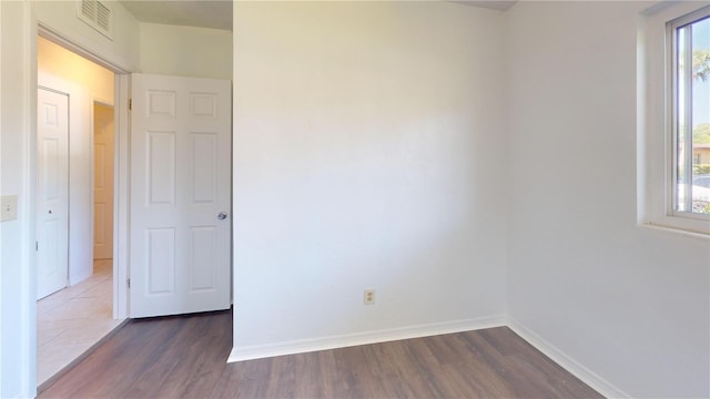 1119 Edith Dr, Daytona Beach, FL 32117 - empty room with healthy amount of natural light and dark wood-style floors