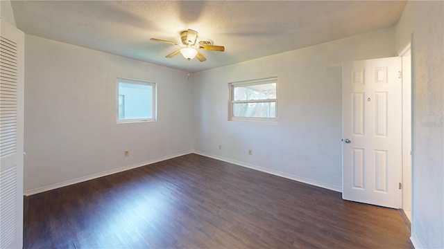 1119 Edith Dr, Daytona Beach, FL 32117 - unfurnished bedroom with multiple windows, dark wood-type flooring, and a ceiling fan