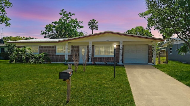 1119 Edith Dr, Daytona Beach, FL 32117 - ranch-style house with a garage, brick siding, driveway, and a yard