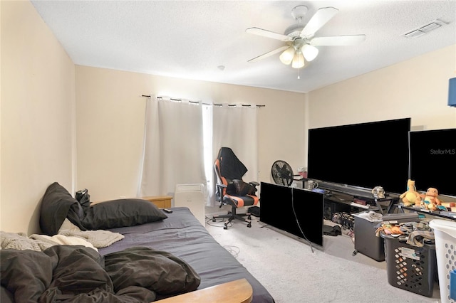 carpeted office with a ceiling fan and a textured ceiling