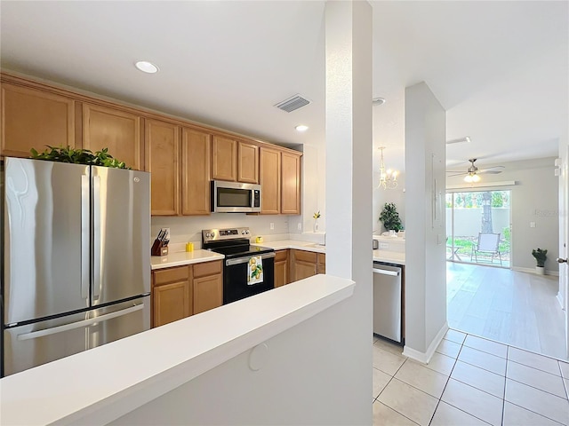 3309 Wilshire Way Rd Unit 3, Orlando, FL 32829 - kitchen with appliances with stainless steel finishes, light countertops, light tile patterned floors, a ceiling fan, and recessed lighting