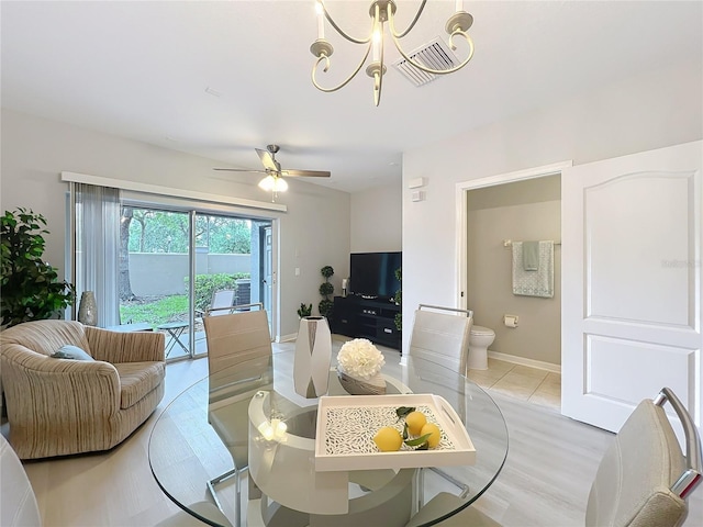 3309 Wilshire Way Rd Unit 3, Orlando, FL 32829 - dining room featuring a chandelier, a ceiling fan, and light tile patterned floors