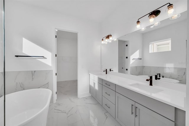 13081 Sunrise Harvest Dr, Winter Garden, FL 34787 - bathroom with marble finish flooring, a freestanding bath, double vanity, and a walk in closet